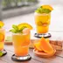 Drie glazen oranje kombucha met sinaasappel en munt