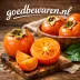 Hele en doorgesneden oranje kaki's op een houten plank